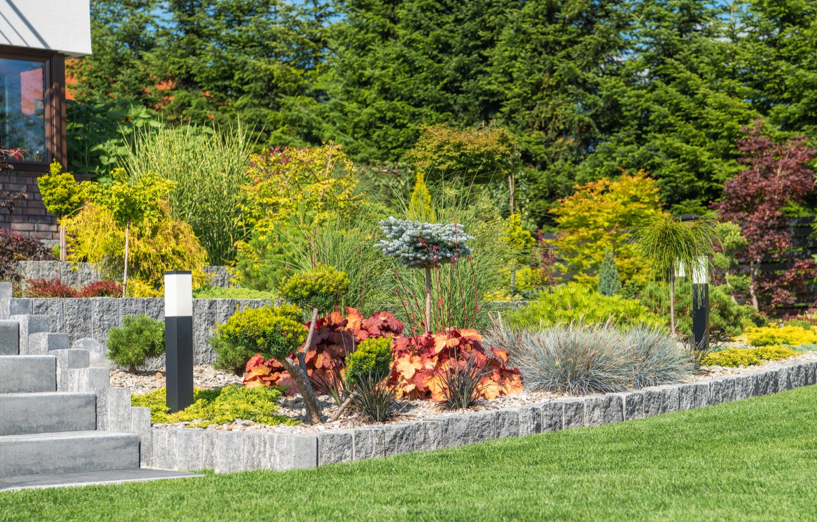 Modern rockery garden landscaped in front of a home by Your Company Name